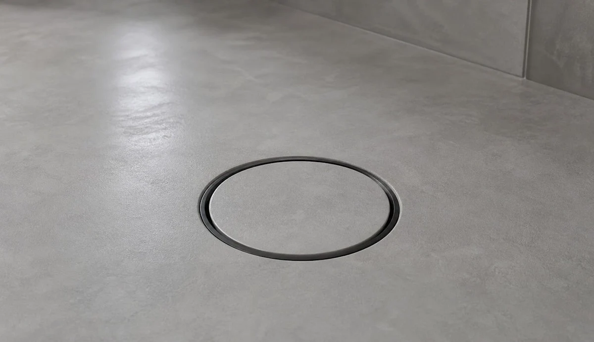 Minimal wetroom drain grid designed for microcement flooring