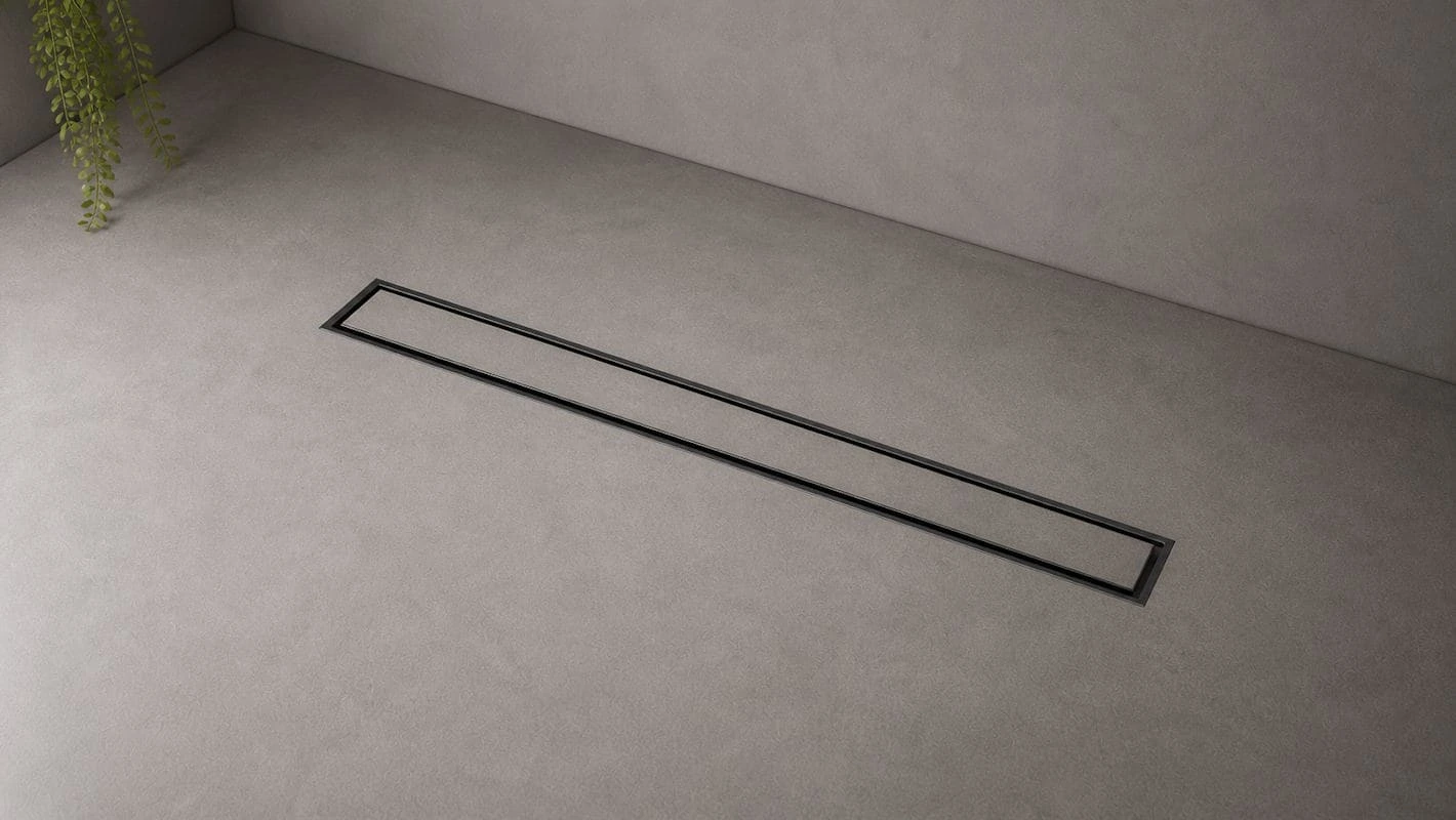 Minimal linear drainage integrated into a seamless microcement wet room floor