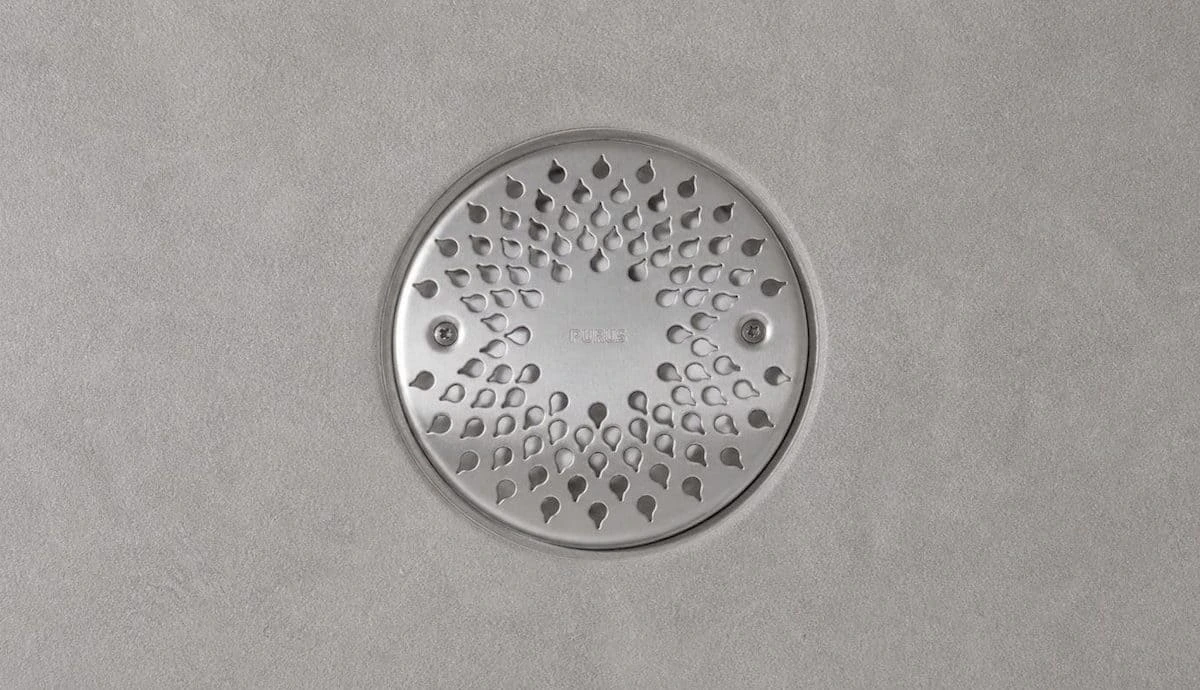 Wetroom drain grate fitted with security locking fixings