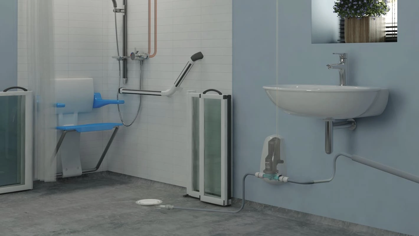 Low-profile pumped shower waste with small bore outlet connection