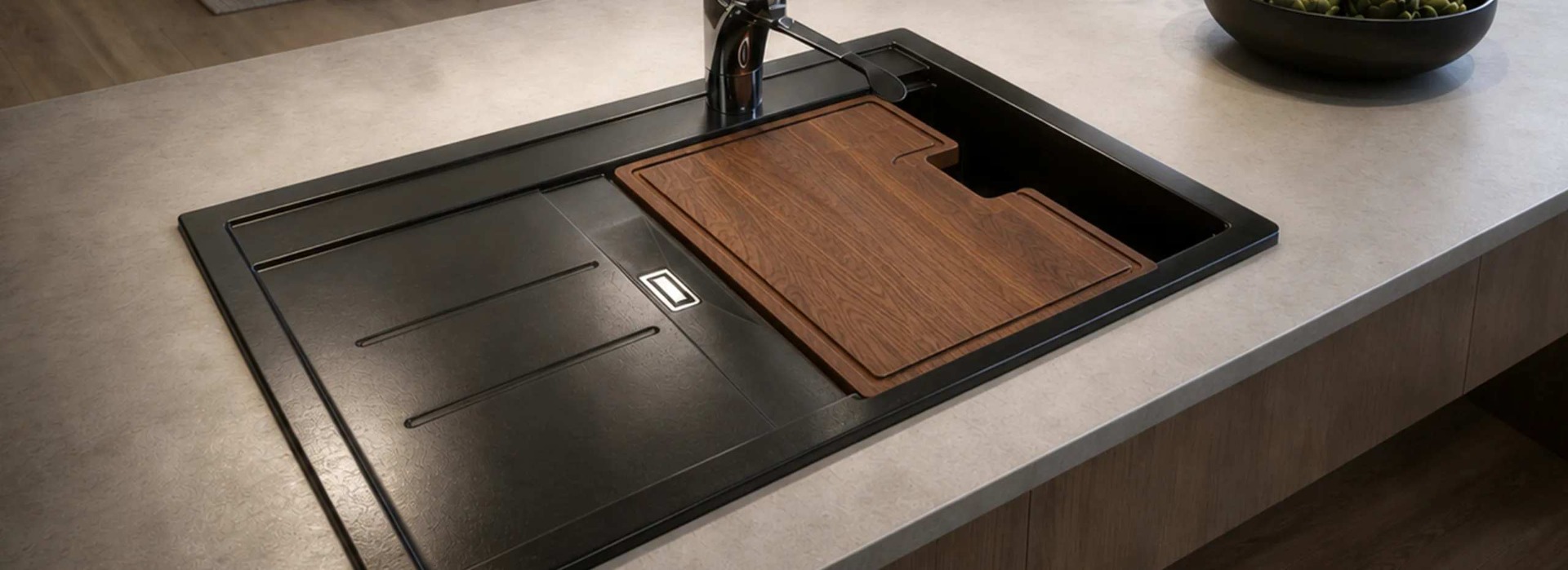 A stylish granite shallow bowl kitchen sink with a wood cover