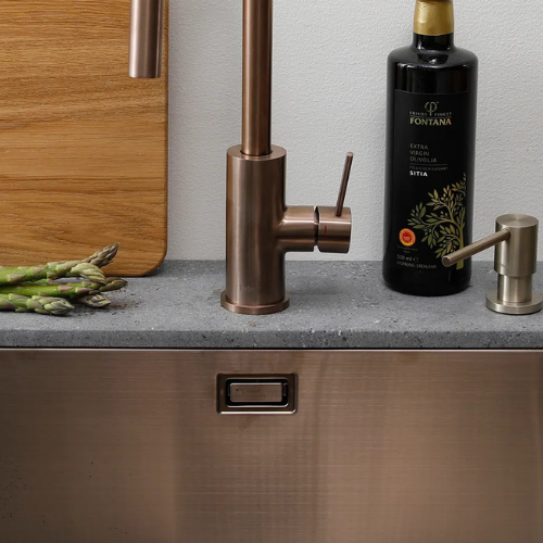 Wheelchair user approaching an accessible shallow bowl kitchen sink