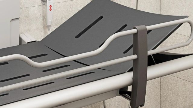 Pressalit shower changing table positioned within an assisted showering area