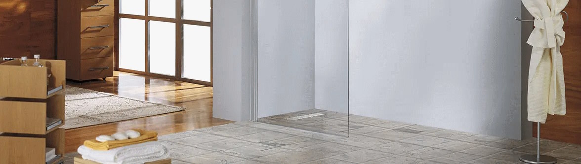 Accessible Showers and Wet Rooms Accessible Wet Room Shower Adaptation, with lever access floor former, linear drain and tiled floor finish. Full height wet room glass screen