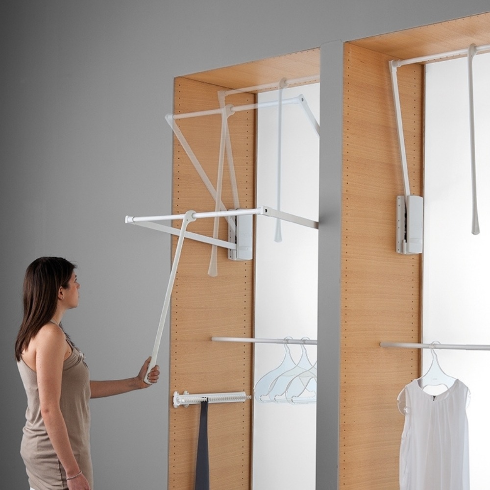 Manual pull down clothes rail lowered inside a wardrobe
