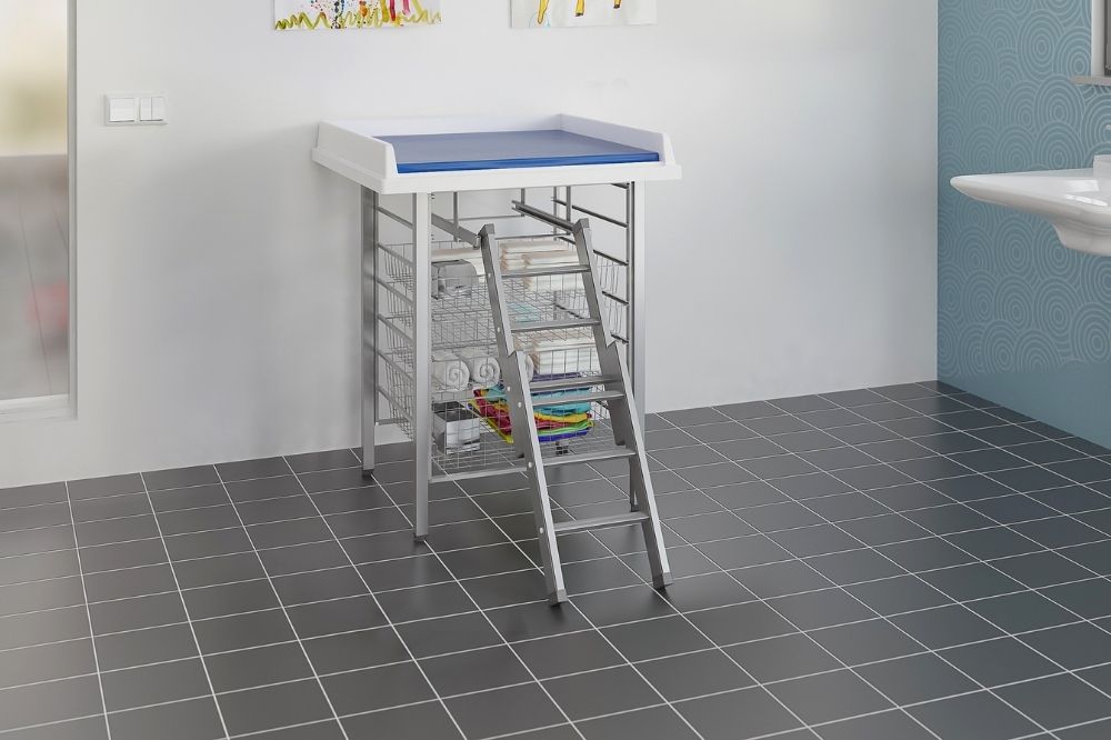 Granberg fixed-height day-care changing table with integrated storage baskets