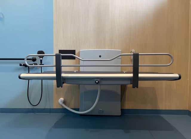 Pressalit shower changing table in an accessible shower and changing environment