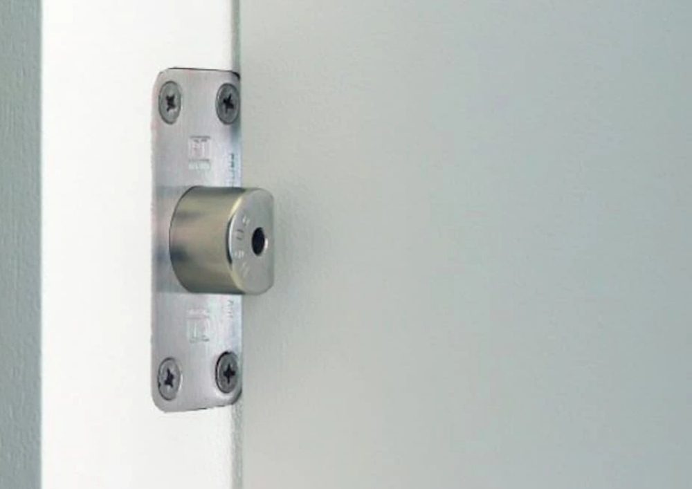 Emergency-release door stop fitted into a bathroom door frame