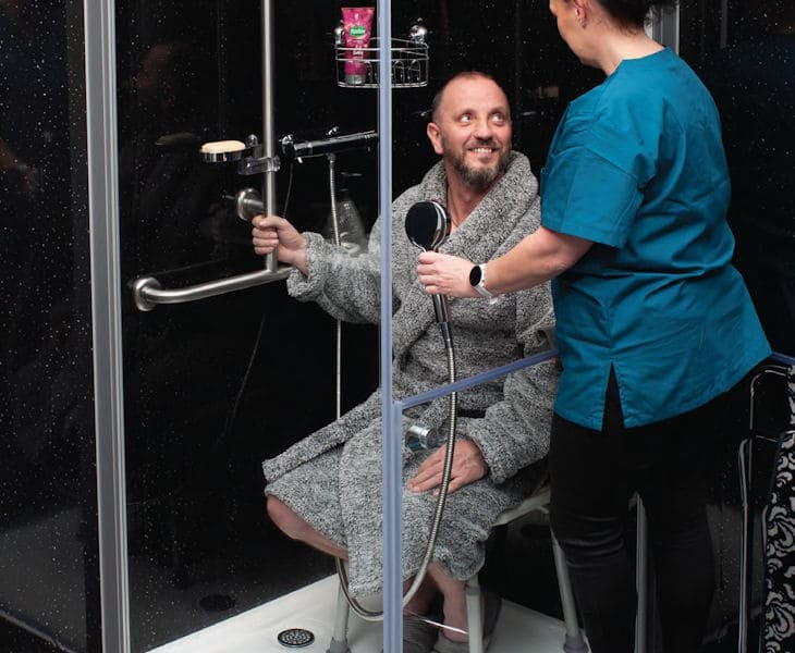 AWS Liberation accessible showering system with half-height shower doors and screens