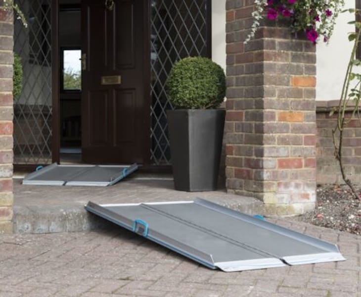 Full-width portable aluminium ramp providing wheelchair access over a step