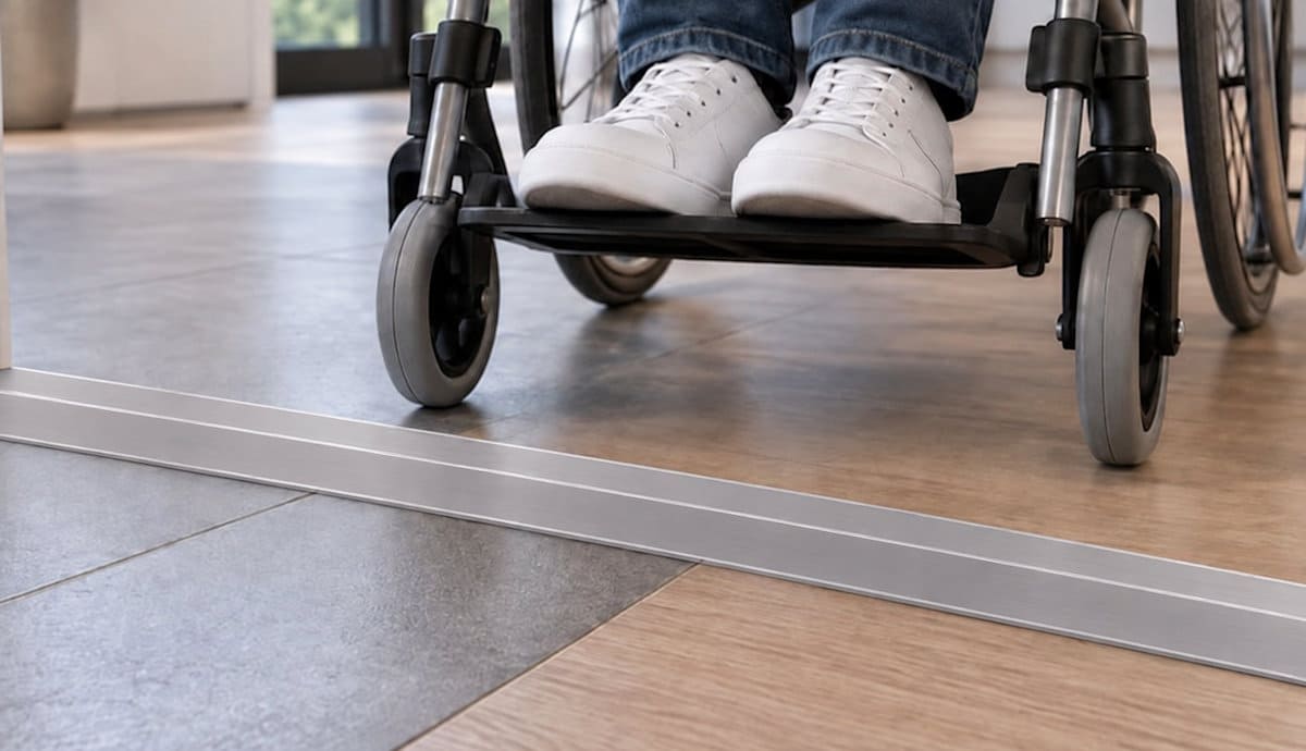 Wheelchair approaching a 6.4 mm high grooved low-profile aluminium doorway threshold