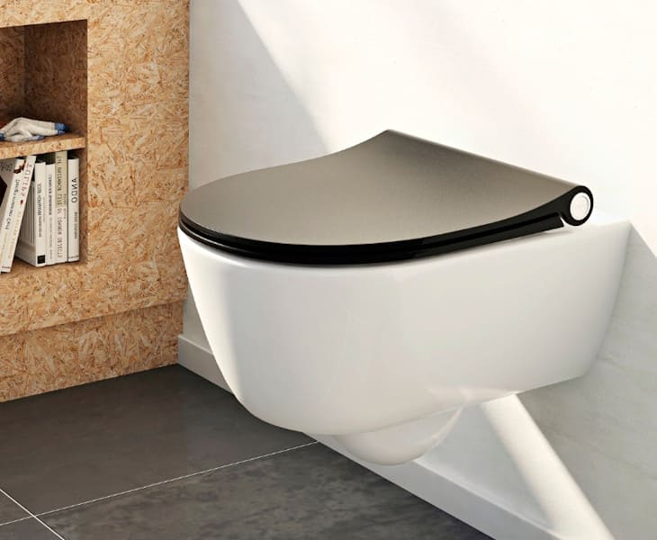 Toilet seat with cover fitted to a WC in an accessible bathroom setting