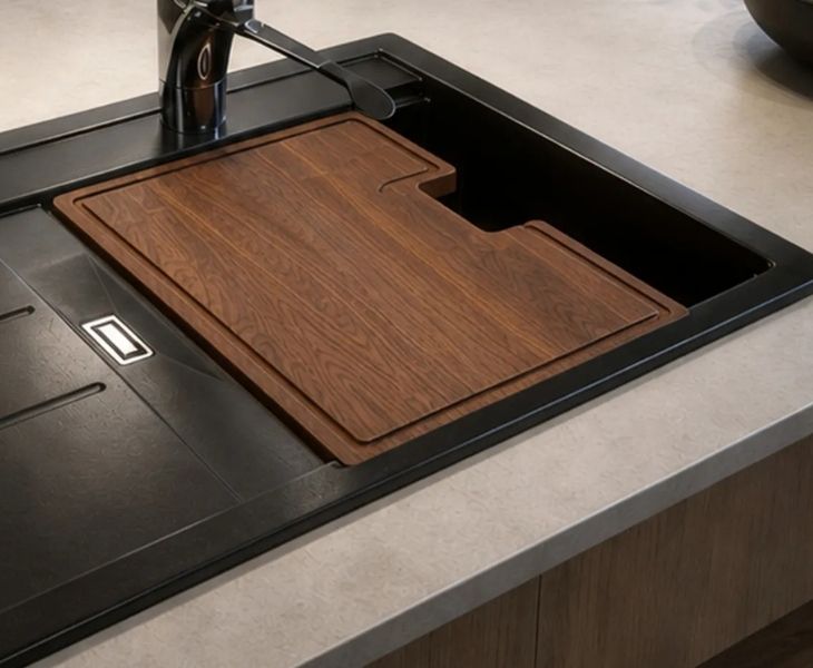 Sapele wooden chopping board fitted over a Granberg granite kitchen sink