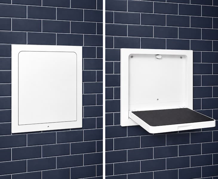 Concealed folding shower seat recessed into a wall