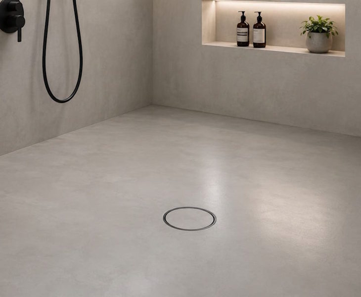 Microcement wet room floor former with integrated drainage falls