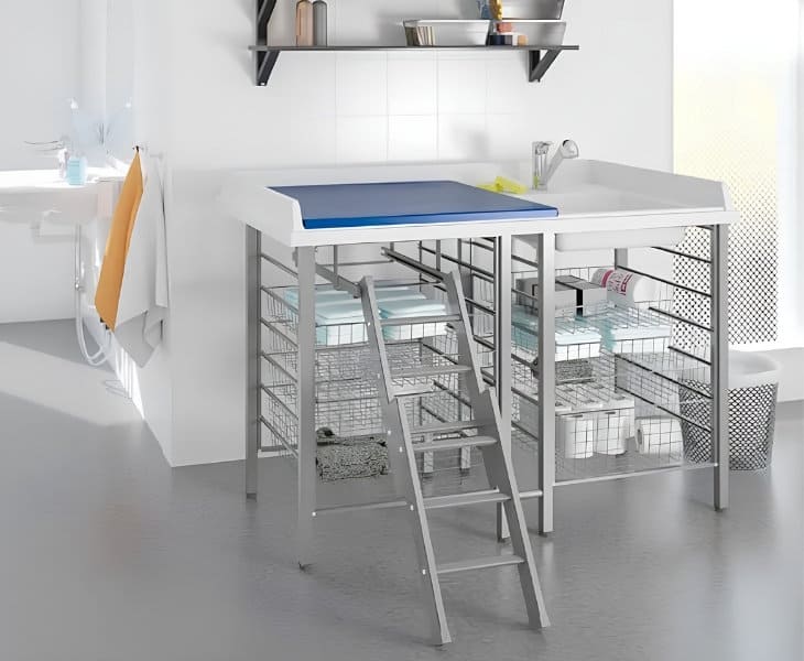 Granberg 327 fixed height day-care changing table with laundry sink and storage baskets