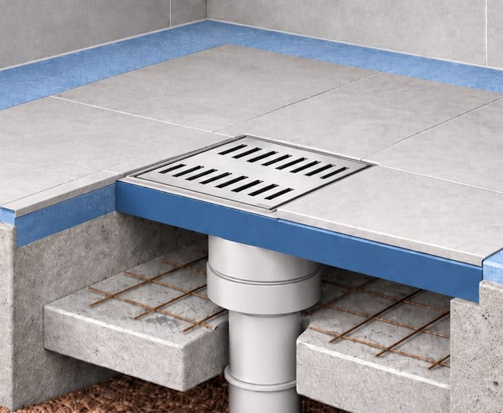 Square shower waste grid fitted above a vertical outlet drain