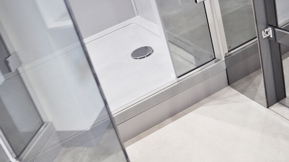 Roman Anti-Slip Shower Tray with Roman full height corner shower enclosure, single door and fixed end panel.